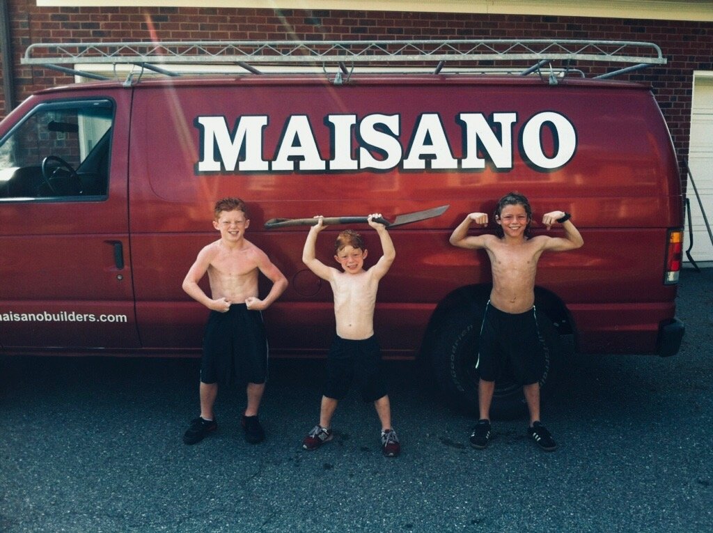 Jake, Declan, and Bodie Maisano as kids posing in front of the original Maisano work van